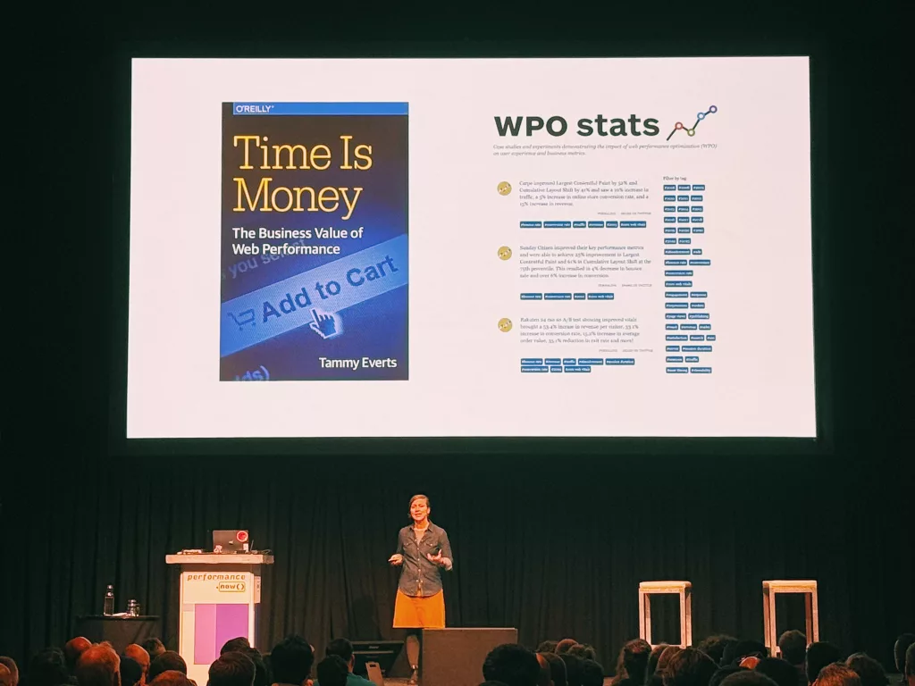 Tammy Everts presenting at perfnow with her book "Time is Money" and WPO stats on screen